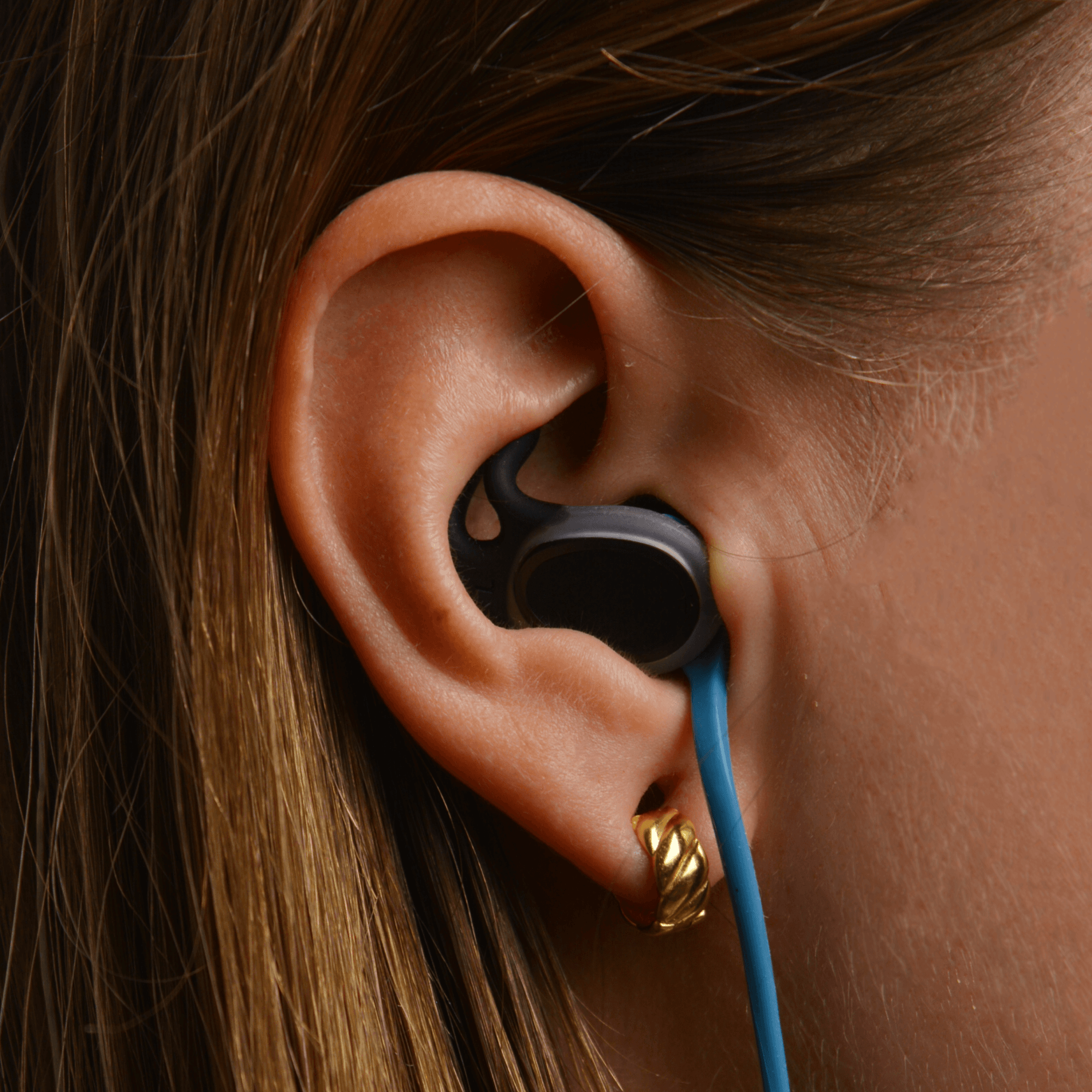 Close-up of a SEAR earplug worn in the ear
